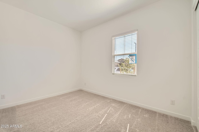 carpeted spare room with baseboards