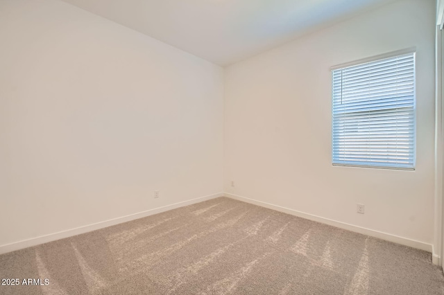carpeted spare room with baseboards