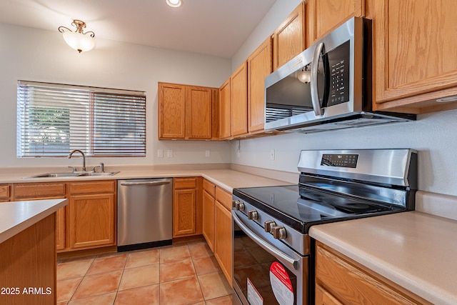 2421 W Indigo Dr, Chandler, AZ 85248 - kitchen featuring appliances with stainless steel finishes, a sink, light countertops, and light tile patterned floors