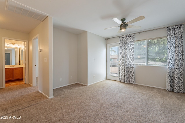 2421 W Indigo Dr, Chandler, AZ 85248 - empty room featuring light colored carpet, a ceiling fan, baseboards, and a sink