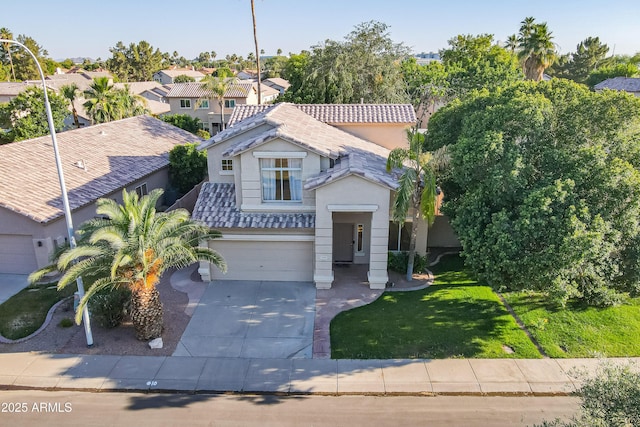 2421 W Indigo Dr, Chandler, AZ 85248 - view of front of home with a tiled roof, concrete driveway, a garage, stucco siding, and a front lawn