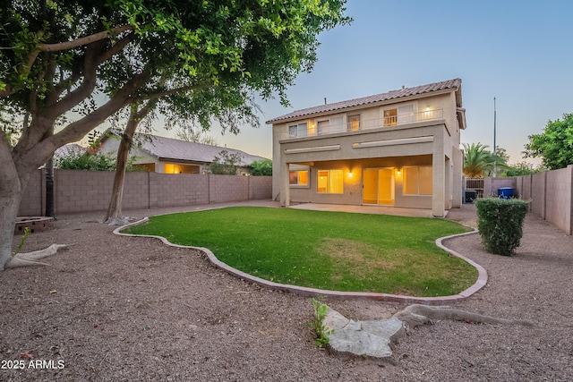 2421 W Indigo Dr, Chandler, AZ 85248 - back of house at dusk featuring stucco siding, a patio, a balcony, and cooling unit