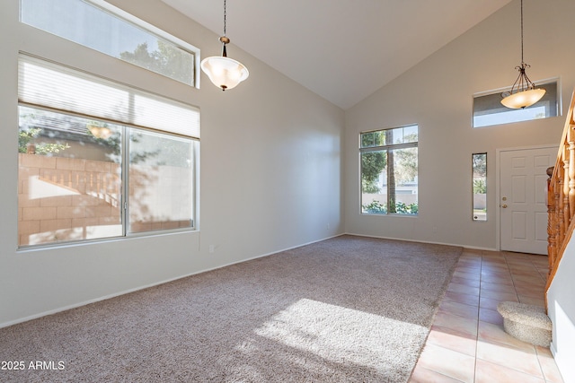 2421 W Indigo Dr, Chandler, AZ 85248 - entrance foyer featuring high vaulted ceiling, baseboards, light tile patterned flooring, and light carpet