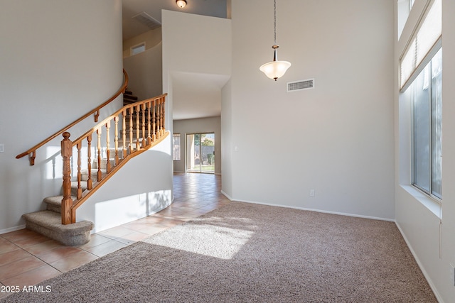 2421 W Indigo Dr, Chandler, AZ 85248 - stairway featuring a towering ceiling, tile patterned flooring, carpet floors, and baseboards
