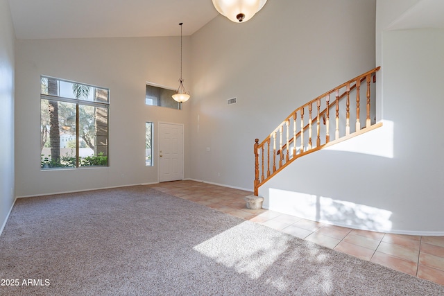 2421 W Indigo Dr, Chandler, AZ 85248 - entryway with high vaulted ceiling, tile patterned flooring, baseboards, stairway, and carpet flooring
