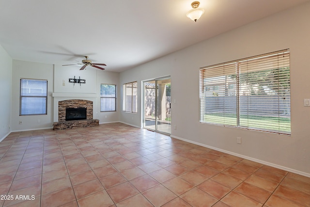 2421 W Indigo Dr, Chandler, AZ 85248 - unfurnished living room featuring a ceiling fan, light tile patterned floors, a fireplace, and baseboards