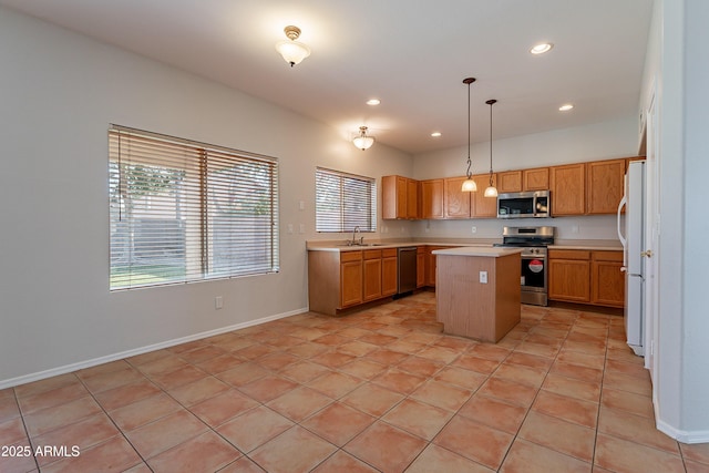 2421 W Indigo Dr, Chandler, AZ 85248 - kitchen with stainless steel appliances, light countertops, a center island, a sink, and recessed lighting