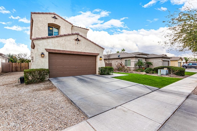 mediterranean / spanish-style home with a garage and a front yard