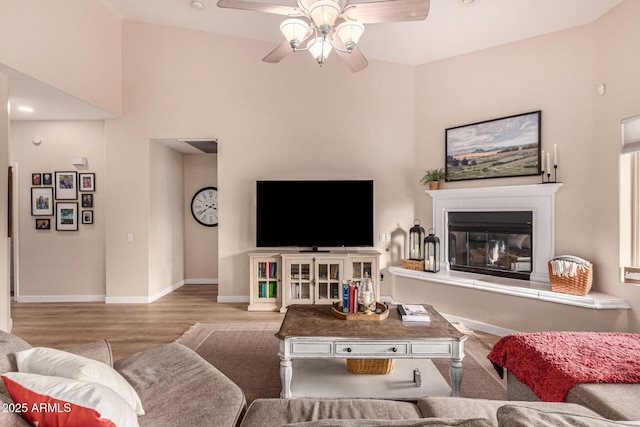 living room featuring ceiling fan and light wood-type flooring