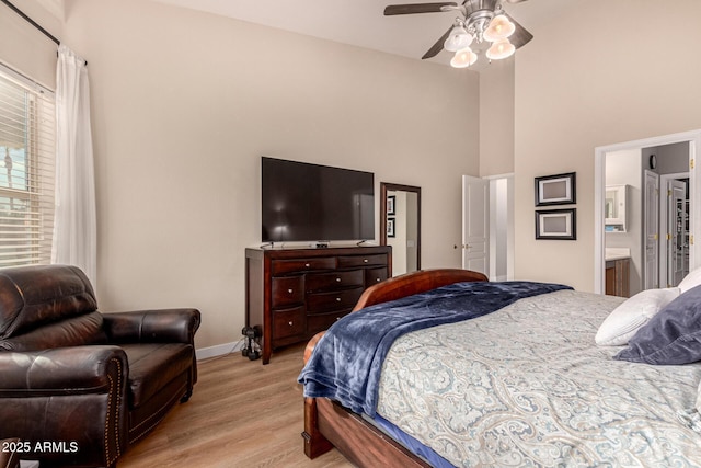 bedroom with light hardwood / wood-style flooring and a high ceiling