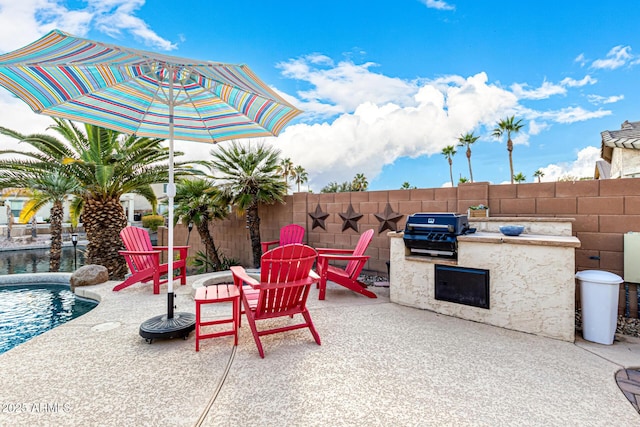 view of patio with area for grilling and an outdoor kitchen