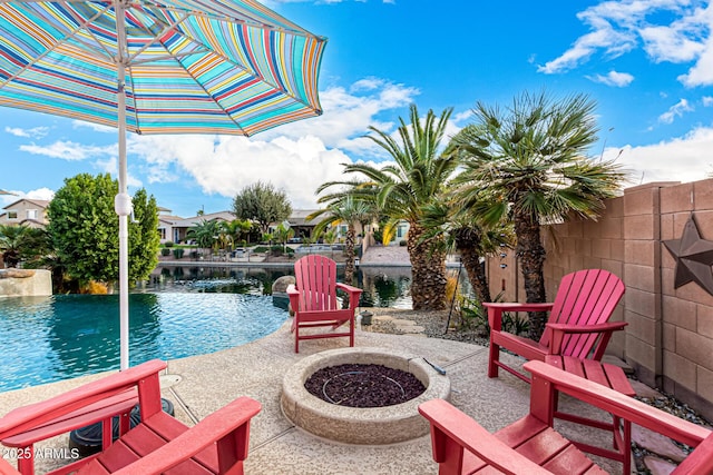 view of patio / terrace featuring a water view and an outdoor fire pit