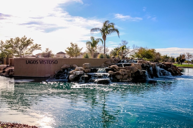 view of swimming pool with a water view