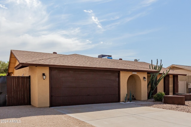 ranch-style home featuring a garage