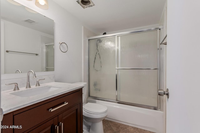 3837 W Dailey St, Phoenix, AZ 85053 - full bathroom featuring toilet, visible vents, tile patterned floors, vanity, and combined bath / shower with glass door