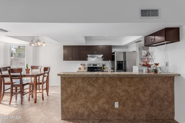 3837 W Dailey St, Phoenix, AZ 85053 - kitchen with light tile patterned flooring, visible vents, under cabinet range hood, dark brown cabinetry, and appliances with stainless steel finishes
