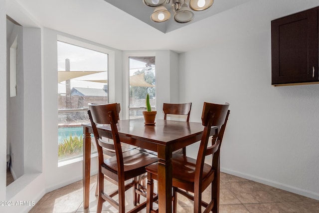 3837 W Dailey St, Phoenix, AZ 85053 - dining area with baseboards, an inviting chandelier, light tile patterned floors, and plenty of natural light