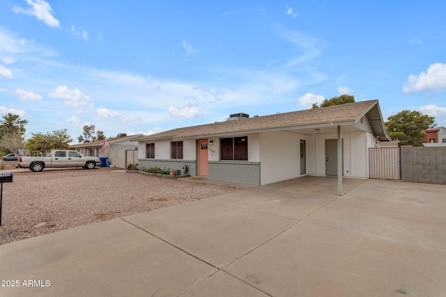 ranch-style home featuring a carport