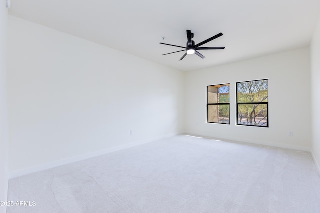 spare room with ceiling fan and light colored carpet