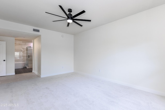 empty room with light colored carpet and ceiling fan