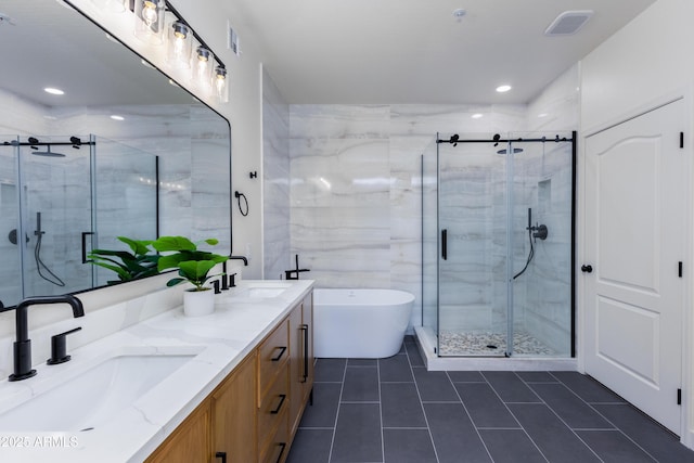 bathroom featuring tile patterned flooring, vanity, and plus walk in shower