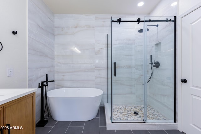 bathroom with vanity, shower with separate bathtub, and tile patterned flooring