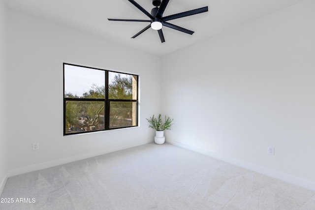 carpeted empty room featuring ceiling fan