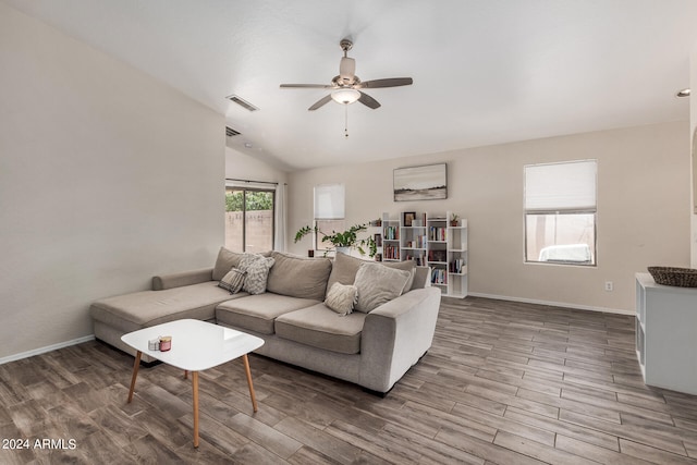 living room with ceiling fan, lofted ceiling, and wood-type flooring