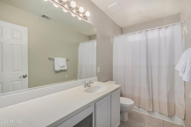 bathroom with walk in shower, tile patterned flooring, vanity, and toilet