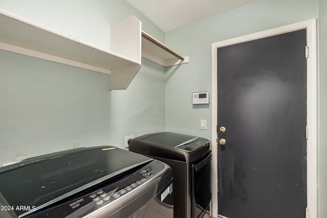 laundry area featuring washing machine and clothes dryer