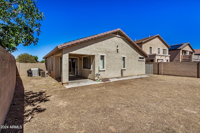 back of property with a patio and cooling unit