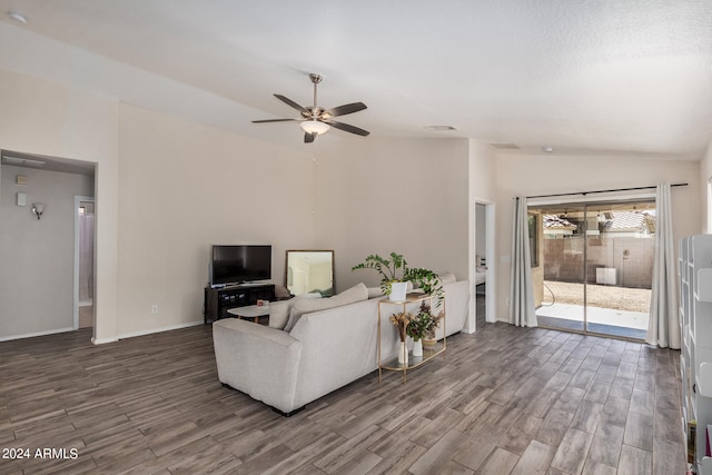 living room featuring lofted ceiling, dark wood-type flooring, and ceiling fan