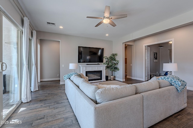 living room featuring hardwood / wood-style flooring and ceiling fan