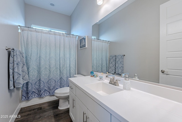 full bathroom with vanity, hardwood / wood-style floors, shower / bath combo with shower curtain, and toilet