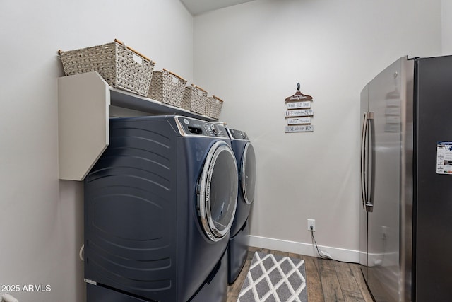 washroom featuring separate washer and dryer and dark hardwood / wood-style floors