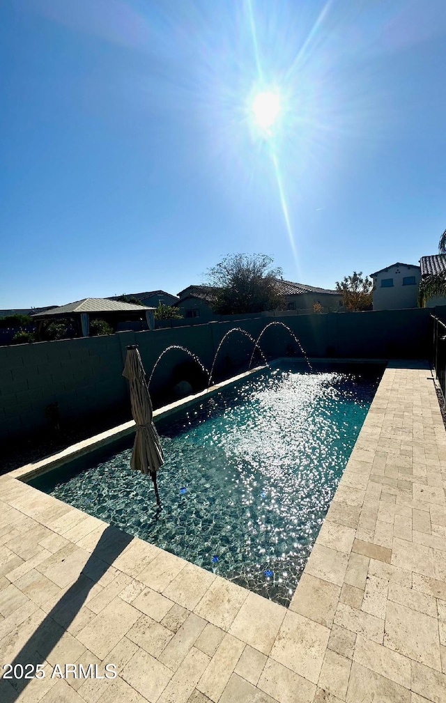 view of pool with pool water feature and a patio area