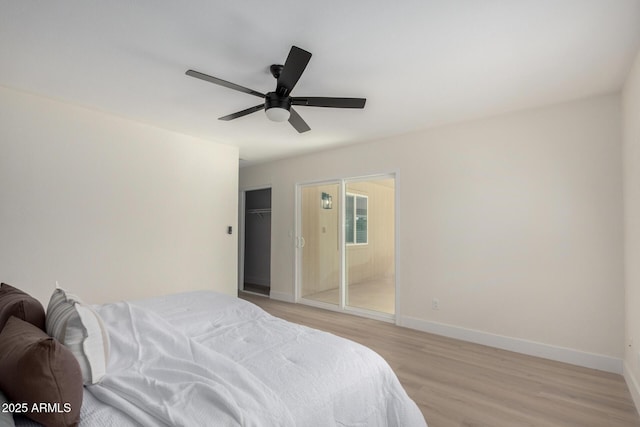 bedroom featuring baseboards, ceiling fan, and light wood-style floors