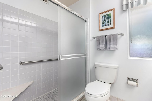 full bath featuring toilet and a stall shower