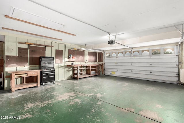 garage with a garage door opener and a workshop area