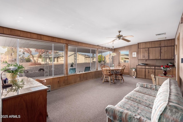 sunroom / solarium with visible vents and a baseboard heating unit