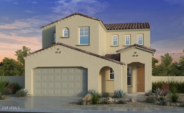 mediterranean / spanish-style home featuring stucco siding, driveway, and a tiled roof