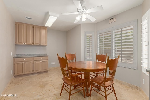 dining space featuring a healthy amount of sunlight, visible vents, ceiling fan, and baseboards