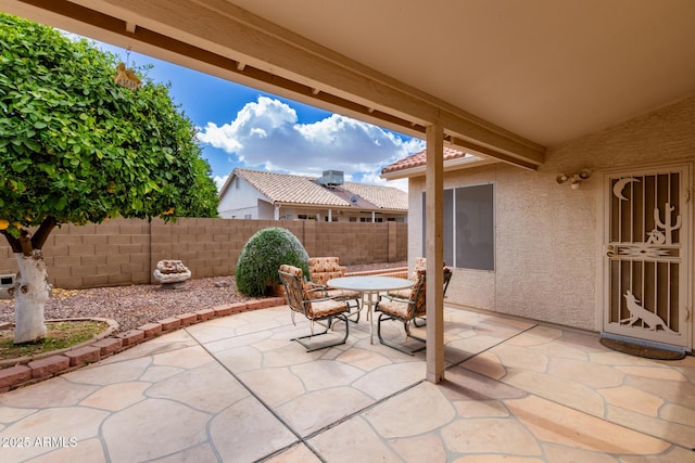 view of patio with fence and outdoor dining area