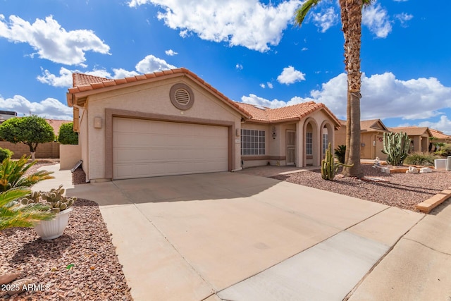 mediterranean / spanish-style house with a garage, a tile roof, driveway, and stucco siding