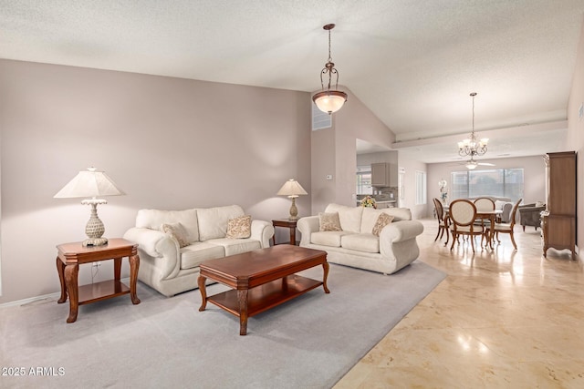 living area with a textured ceiling, vaulted ceiling, and a wealth of natural light