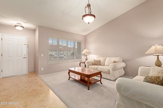 living room with vaulted ceiling, a textured ceiling, and baseboards