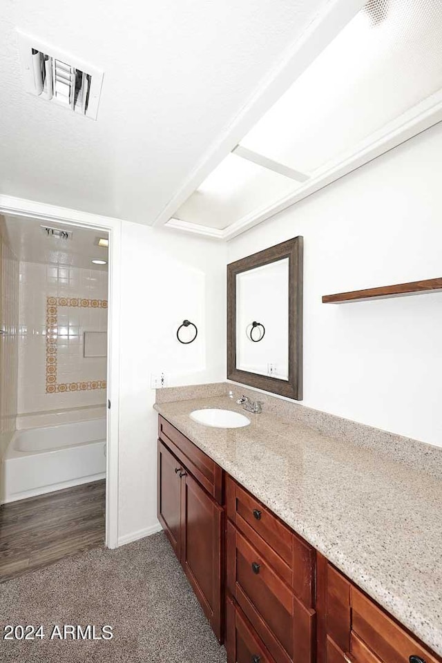 bathroom with vanity and hardwood / wood-style floors