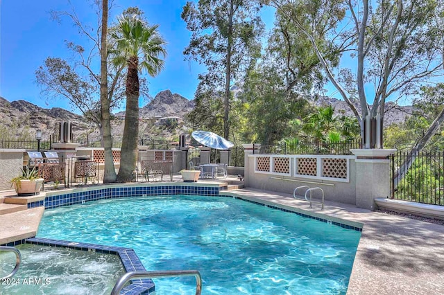 view of swimming pool featuring a mountain view and a patio area