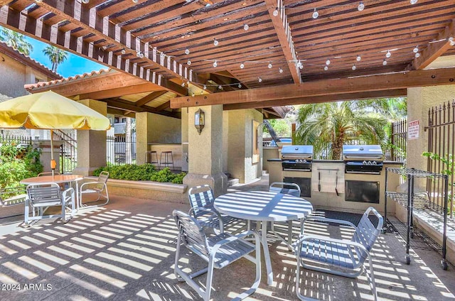 view of patio featuring a pergola, area for grilling, and a grill