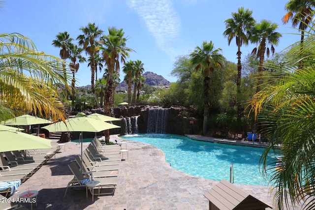 view of swimming pool featuring a mountain view, a patio area, and pool water feature